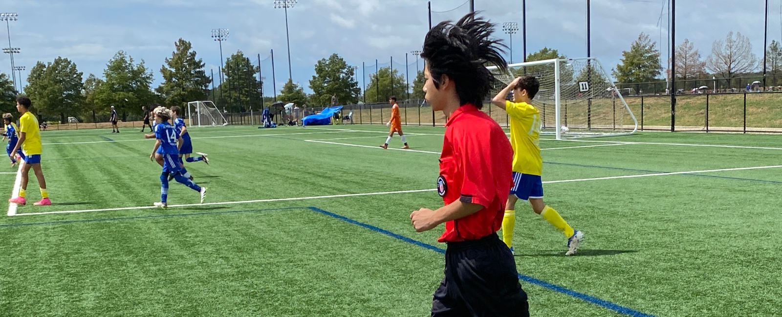 Jeffery Chen officiating a youth soccer match